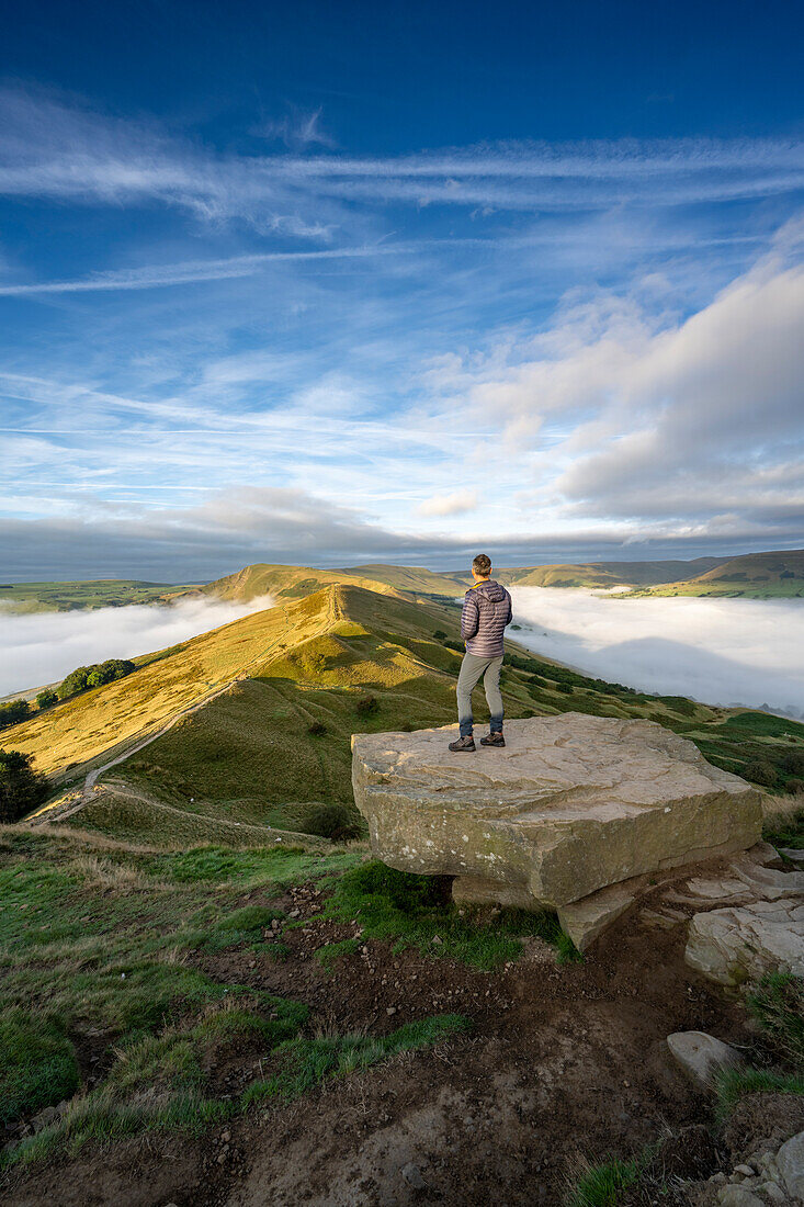 A walker admiring the view across The Great Ridge and Mam Tor, Peak District, Derbyshire, England, United Kingdom, Europe