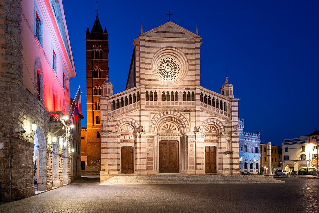 Grosseto Cathedral, Cattedrale di San Lorenzo, to the left illuminated town hall, Grosseto, Tuscany, Italy