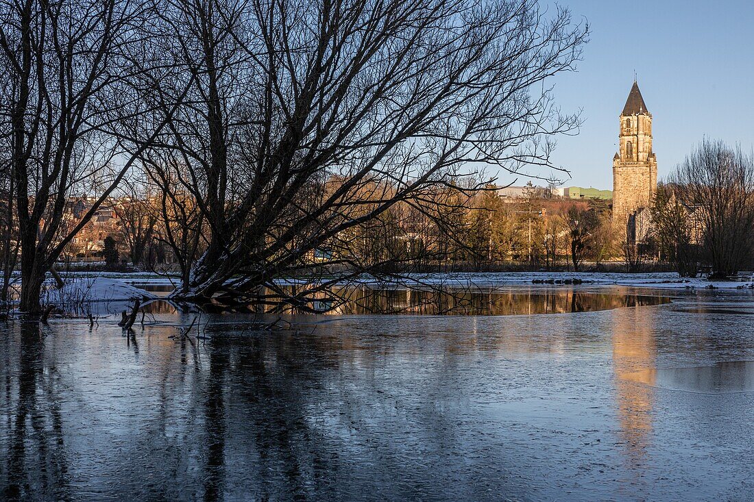 frozen lake in front of the notre-dame church, orbec, calvados, france