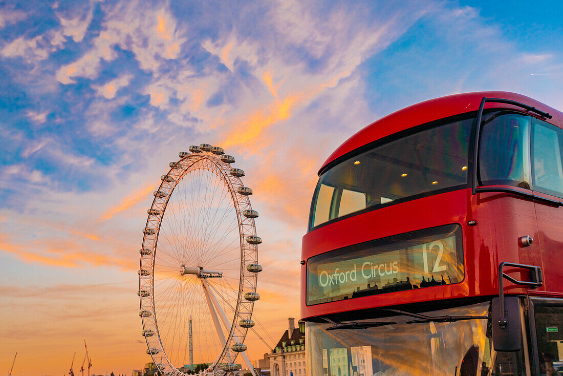 UK, London, Double-decker bus and London Eye at sunset