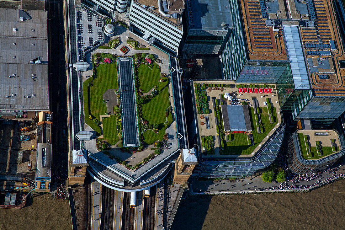 UK. London, Aerial view of rooftop gardens and buildings by Thames river