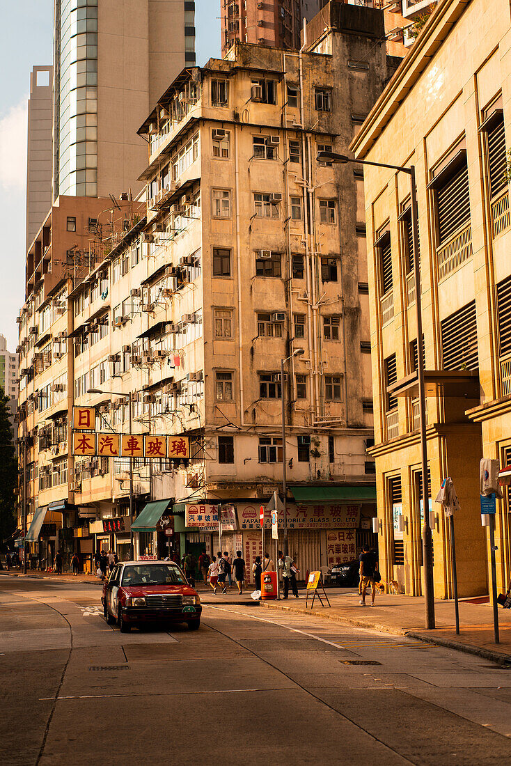 View of residential buildings with car moving on street, Hong Kong