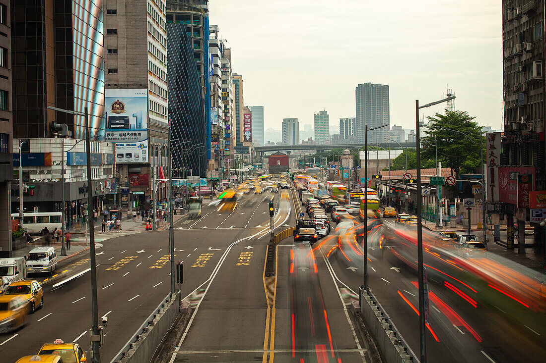 View of modern cityscape with traffic moving on street in Taiwan