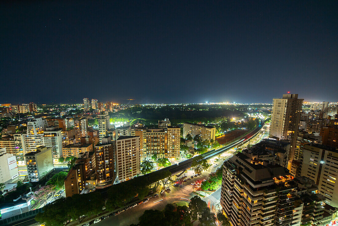 Aerial view of elevated railway bridge passing through city at night