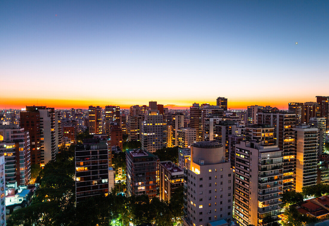 Aerial view of cityscape with residential buildings and office buildings at dusk
