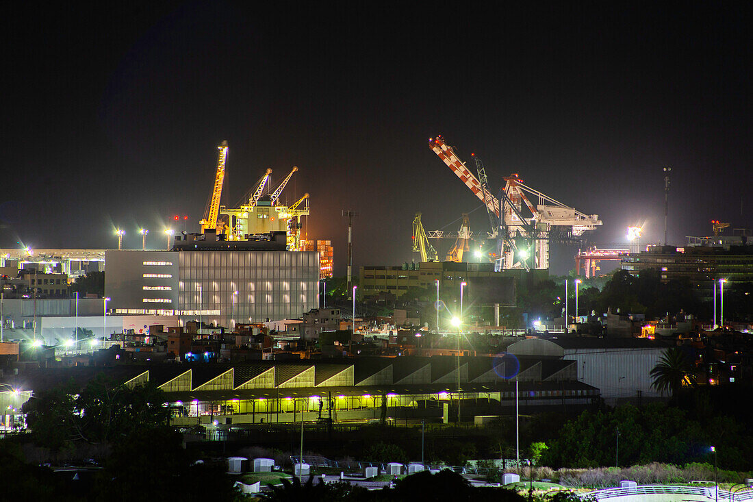 View of industrial warehouses and cranes