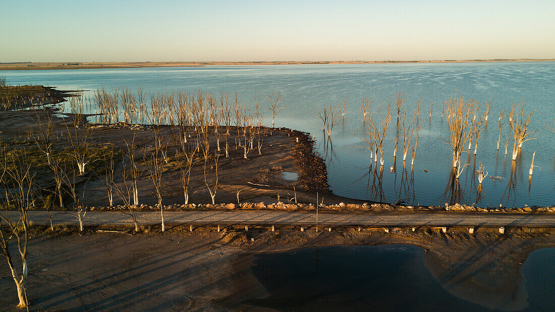 Aerial view of highway passing by Laguna Epecuen