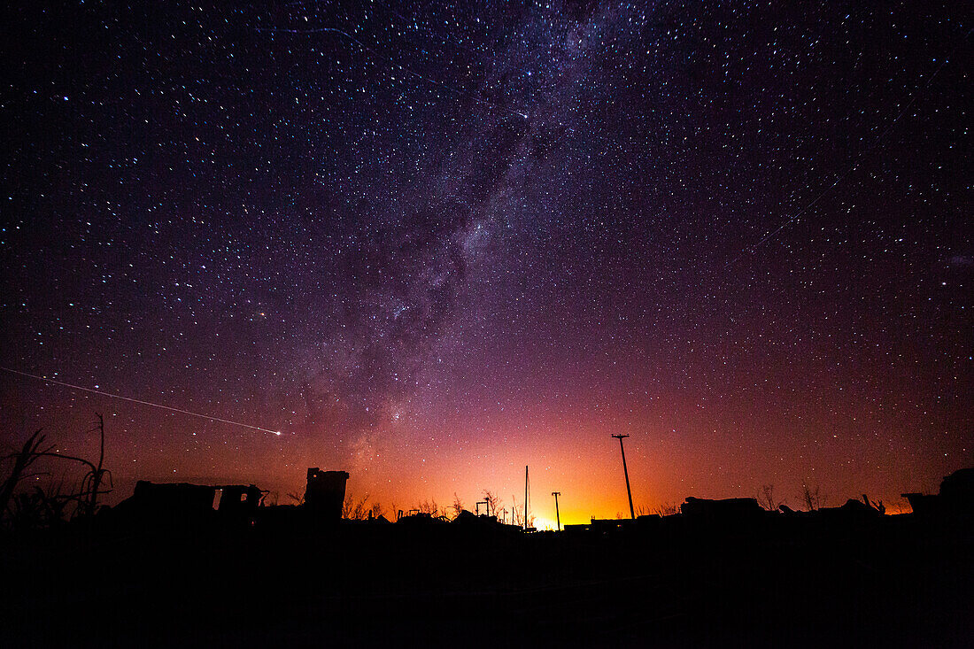View of abandoned village against milky way and star trail in sky, Villa Epecuen