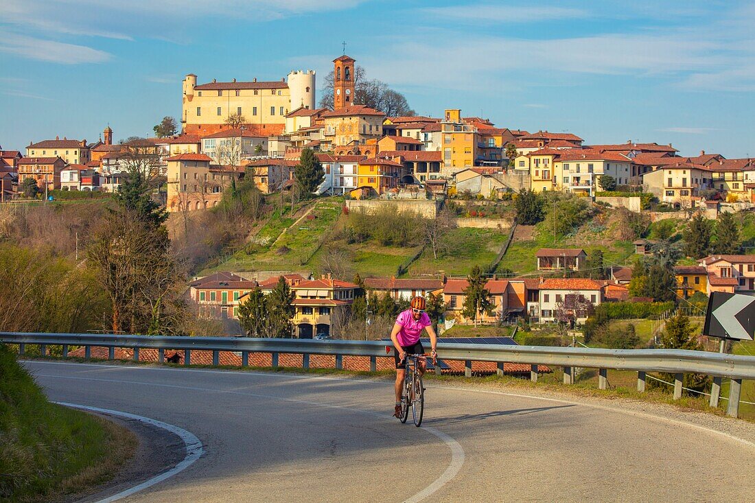 Cyclist leaving Cortanze, Piedmont, Italy, Europe