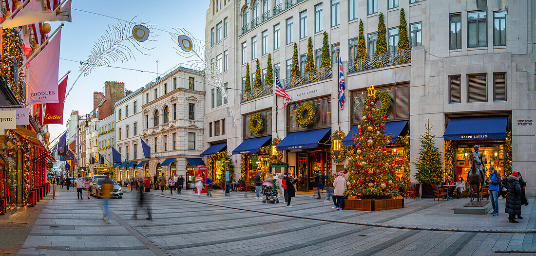 View of Christmas decorations, Christmas tree and shops on New Bond Street at Christmas, London, England, United Kingdom, Europe