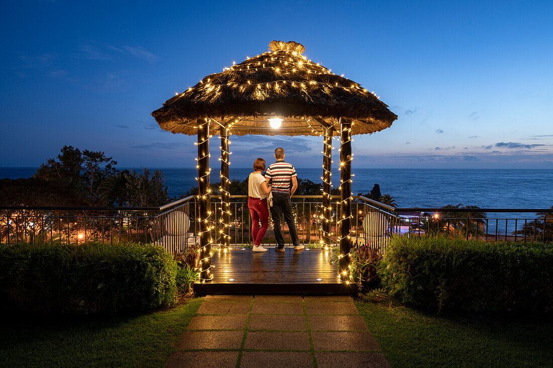 A couple stood looking at the evening sky, Funchal, Madeira, Portugal, Atlantic, Europe