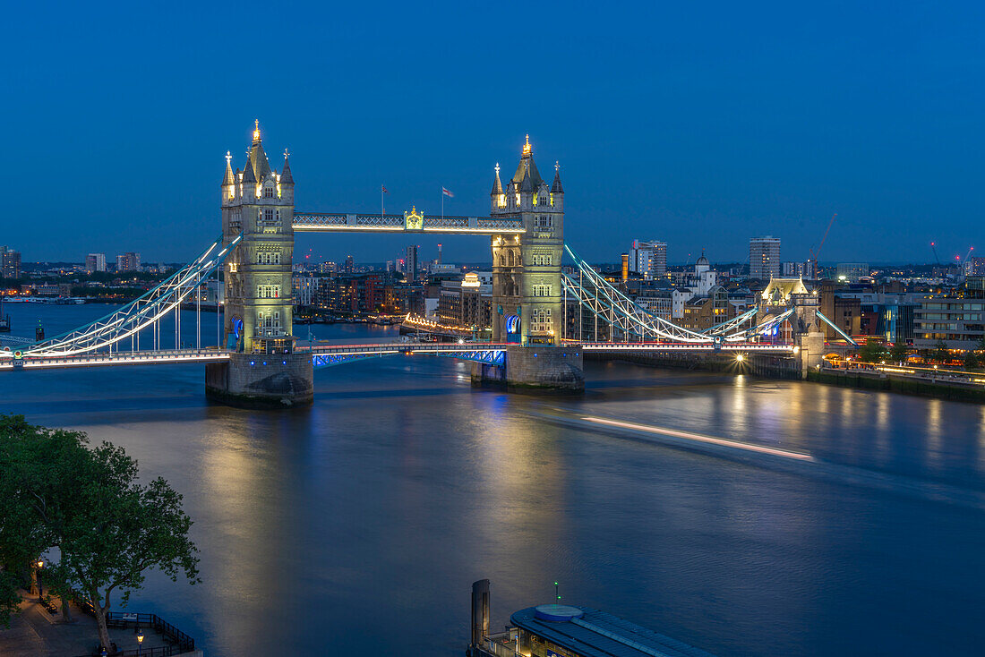 View of Tower Bridge and River Thames from Cheval Three Quays at dusk, London, England, United Kingdom, Europe