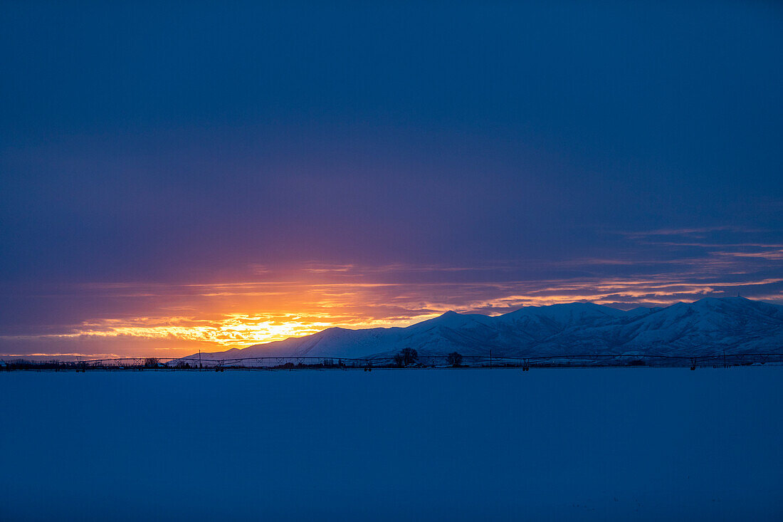 United States, Idaho, Bellevue, Sun rising above snowcapped mountains