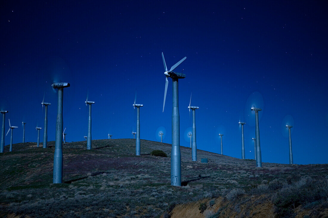 Windkraftanlagen in der Landschaft bei Nacht
