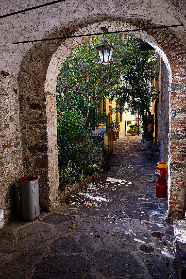 old streets, paths and culverts in the center of Gandria. Whimsical entrance doors and street lamps.