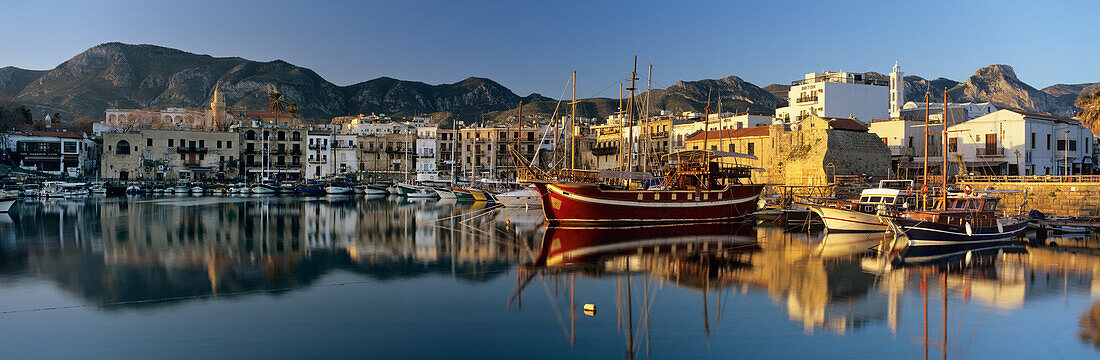 The boat filled harbour and mountains with mirror reflection, Kyrenia (Girne), Northern Cyprus, Cyprus, Mediterranean, Europe