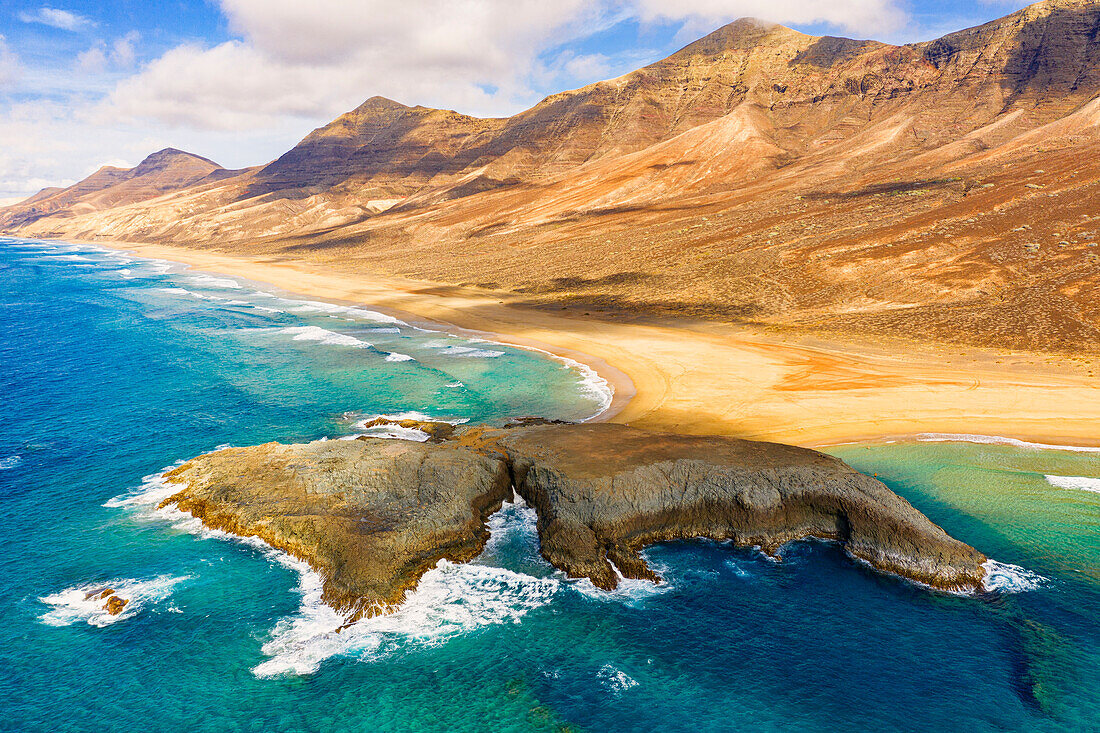 Aerial view of El Islote islet in the crystal ocean along Cofete beach, Jandia, Fuerteventura, Canary Islands, Spain, Atlantic, Europe