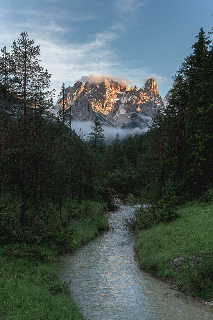River in the green valley with Cristallo and Popena group in the background at sunset, Dolomites, South Tyrol, Italy, Europe