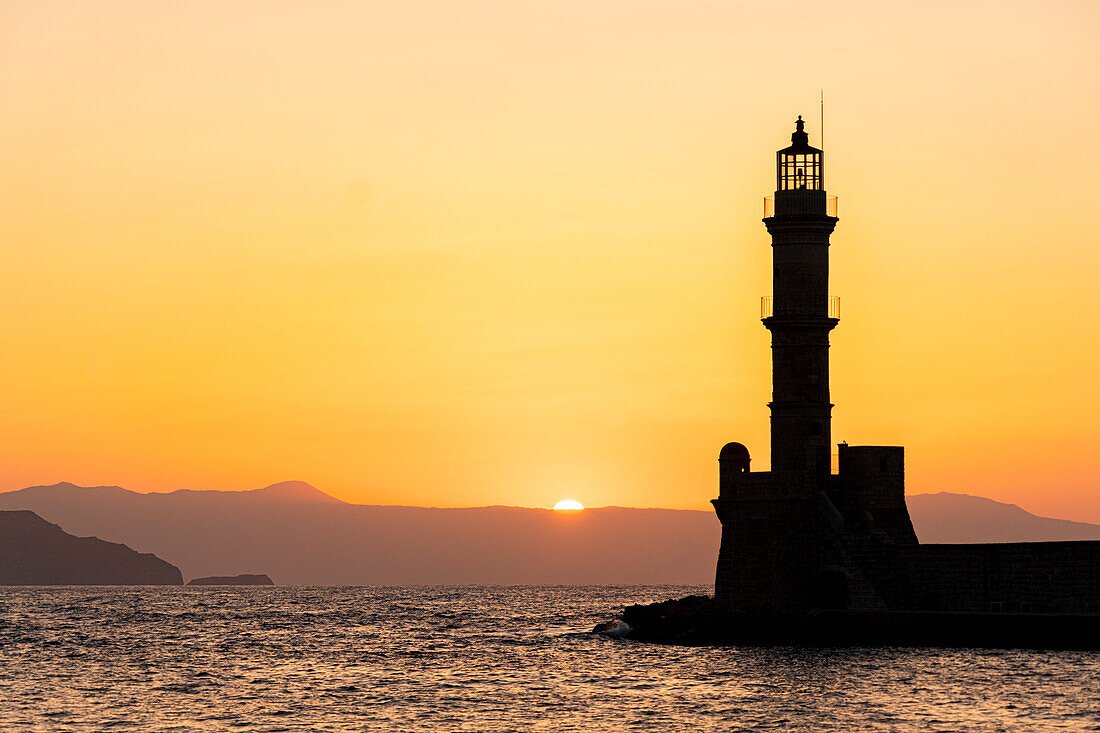 Silhouette of the old lighthouse at sunset, Chania, Crete, Greek Islands, Greece, Europe