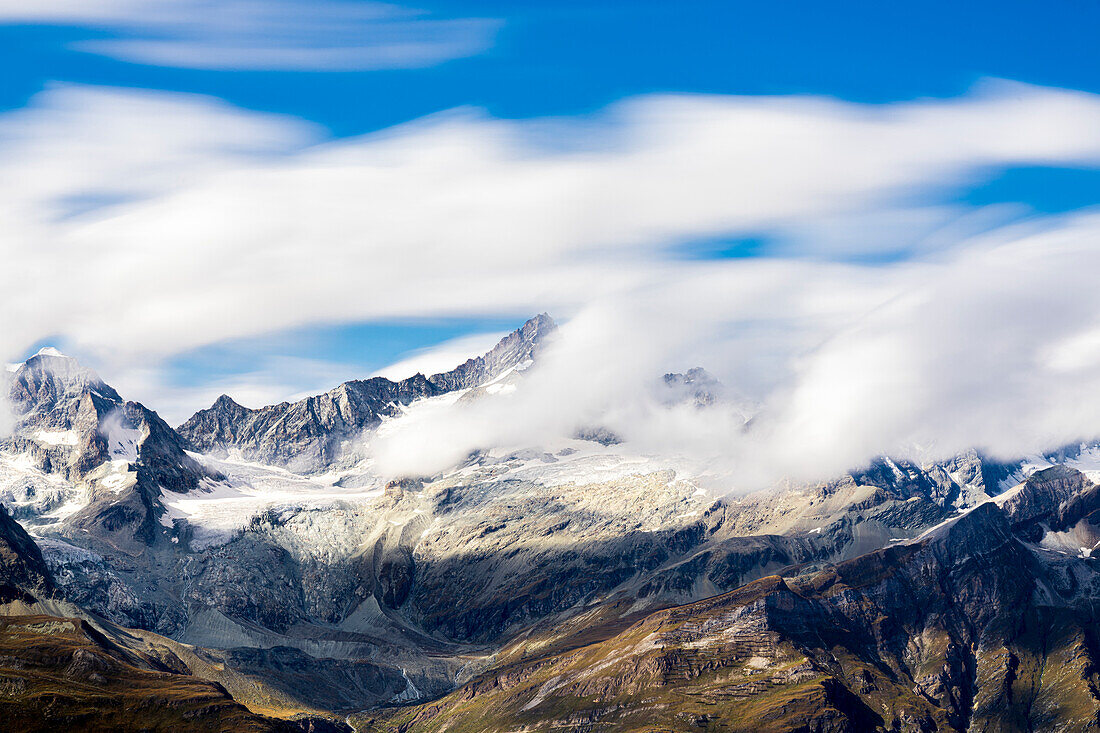Zinalrothorn and Wellenkuppe mountains emerging from cumulus clouds, Valais Canton, Swiss Alps, Switzerland, Europe