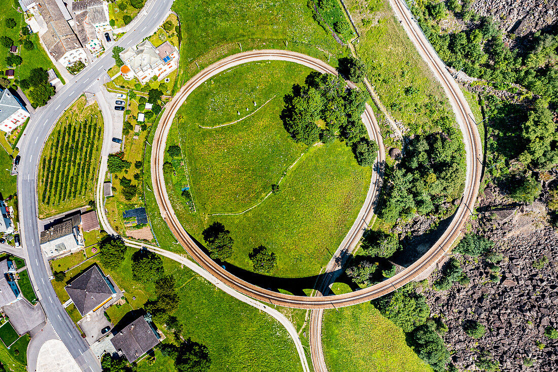 Aerial of the Brusio spiral viaduct, UNESCO World Heritage Site, Rhaetian Railway, Switzerland, Europe