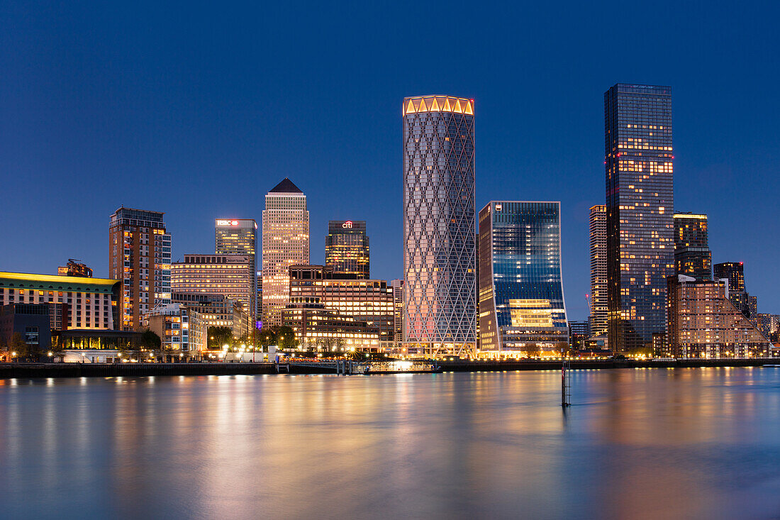 Canary Wharf skyline reflecting in the River Thames at dusk, London, England, United Kingdom, Europe