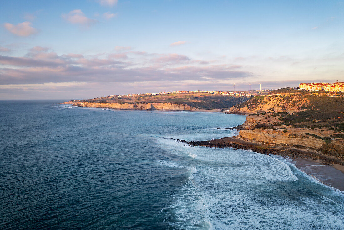 Ericeira drone aerial view on the coast of Portugal with surfers on the sea at sunset, Lisbon area, Portugal, Europe