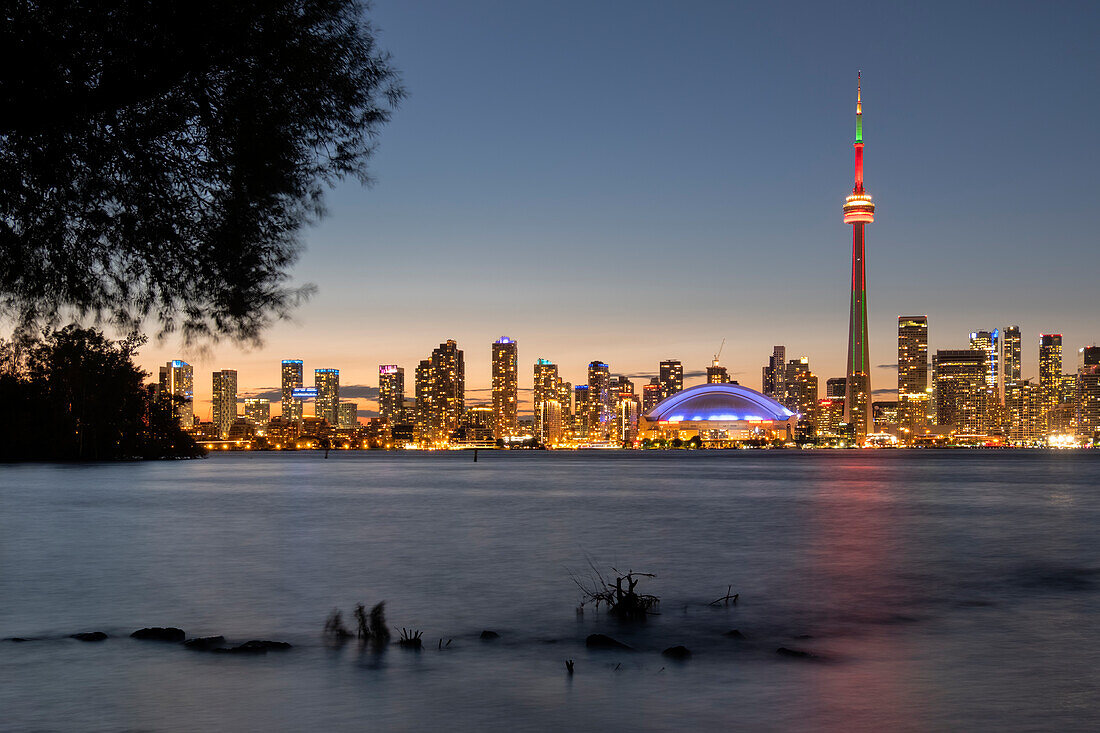 Toronto skyline featuring the CN Tower at night across Lake Ontario, from Toronto Islands Park, Toronto, Ontario, Canada, North America