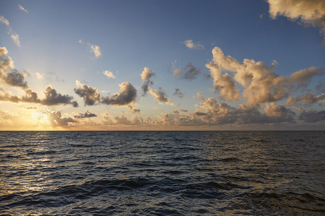 Clouds over ocean at sunrise