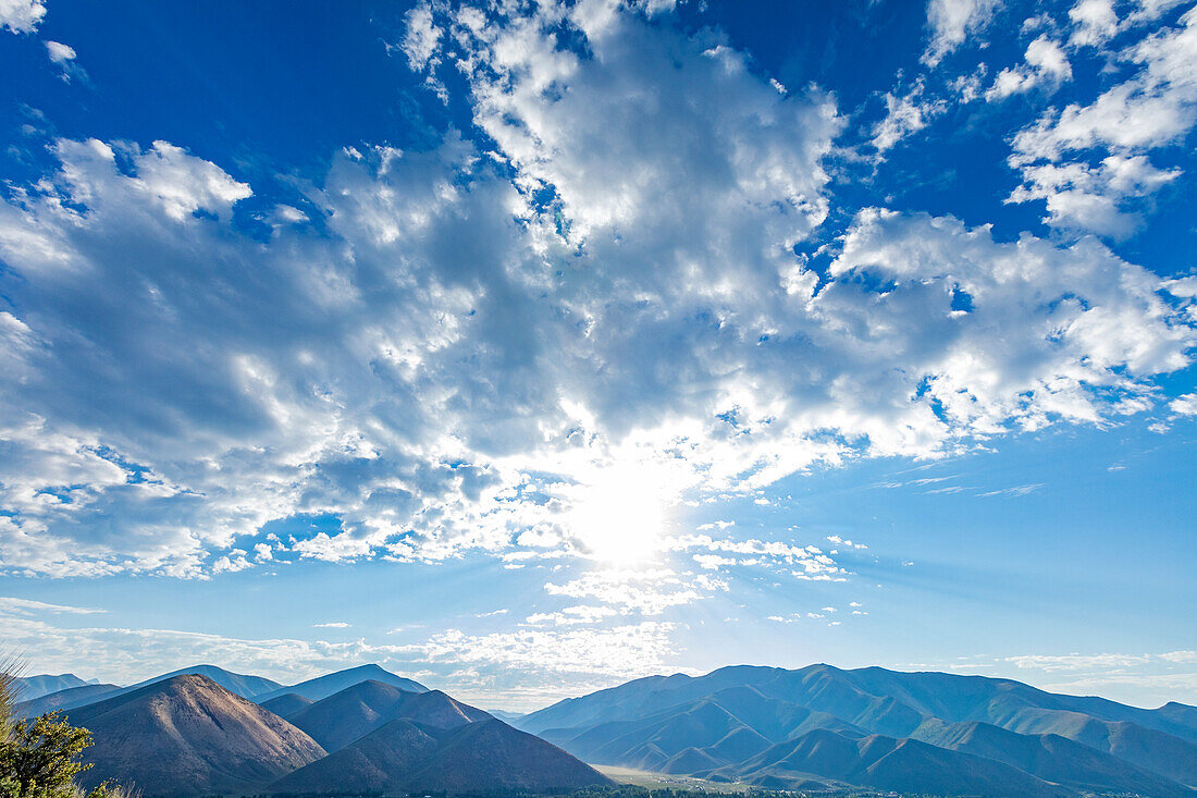 USA, Idaho, Hailey, Sun and clouds over mountain landscape