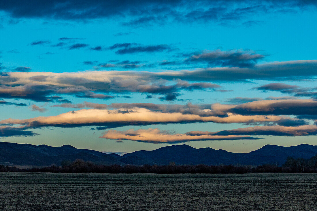 USA, Idaho, Bellevue, Sunset clouds over field and mountains