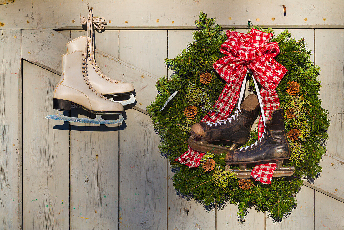 USA, Massachusetts, Essex, ice skates and Christmas wreath