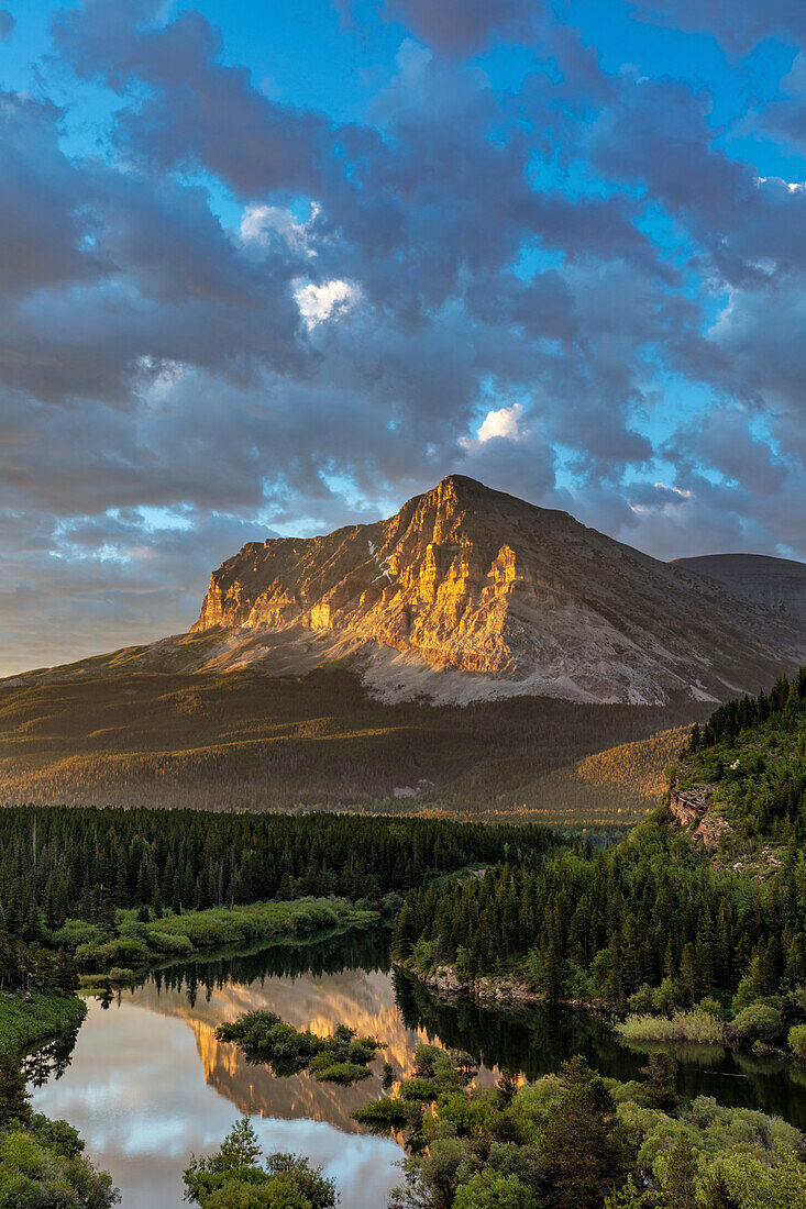 Wynn Mountain catching morning light above Swiftcurrent Creek in Glacier National Park, Montana, USA.