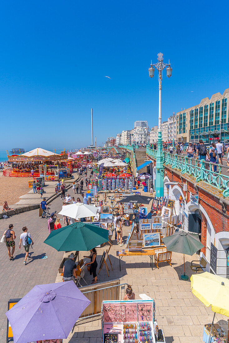 View of seafront carousel and colourful souvenir stalls, Brighton, East Sussex, England, United Kingdom, Europe