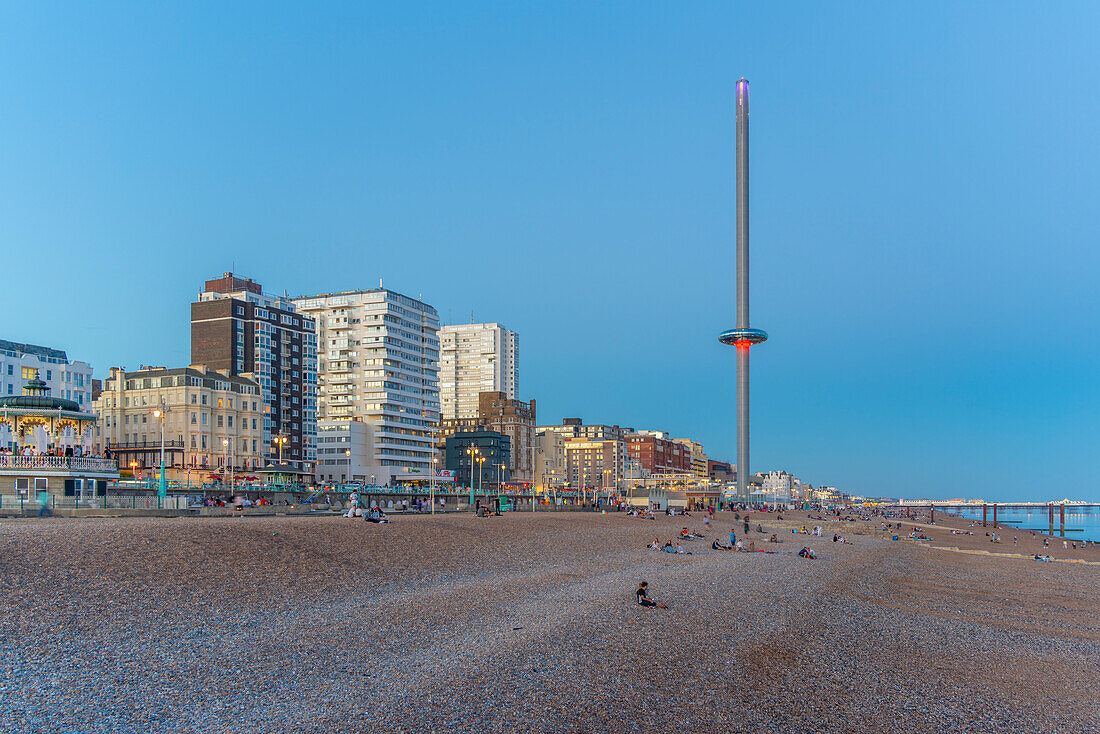 View of beach and British Airways' i360 viewing tower at dusk, Brighton, East Sussex, England, United Kingdom, Europe