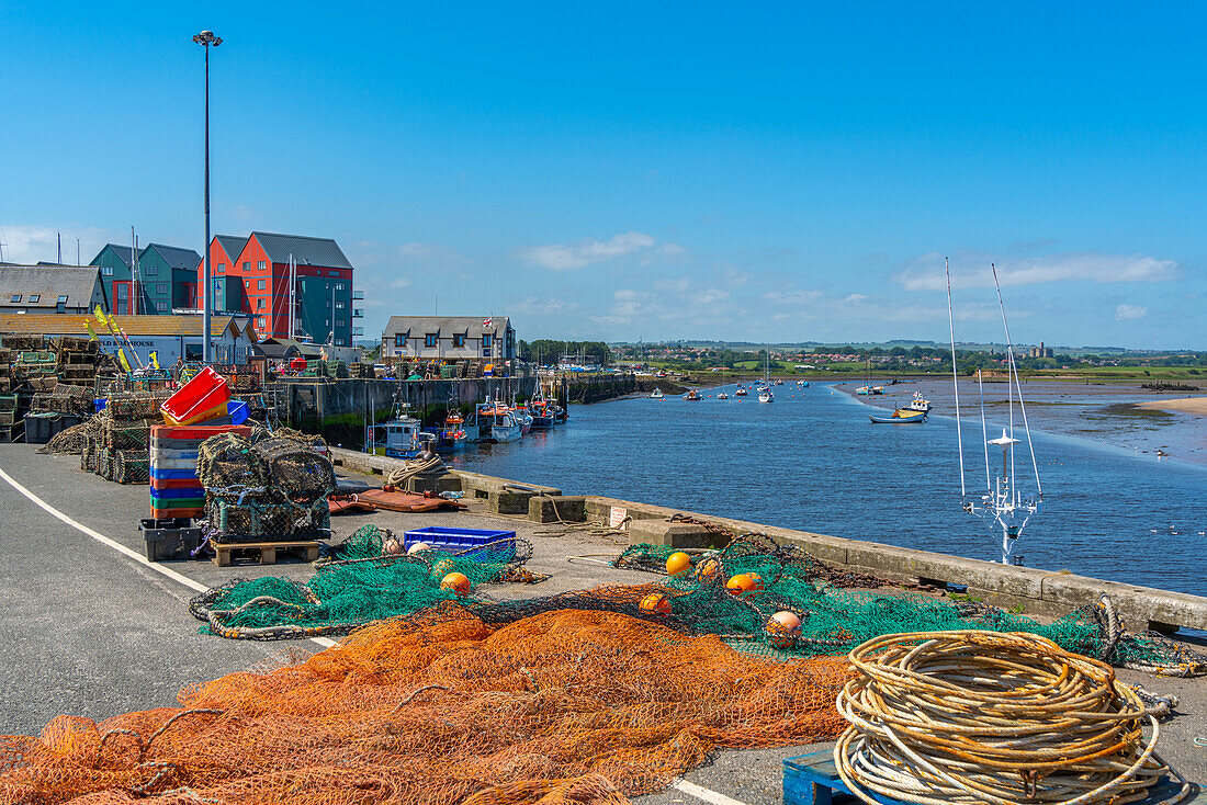View of fishing nets on quayside and River Coquet at Amble, Morpeth, Northumberland, England, United Kingdom, Europe