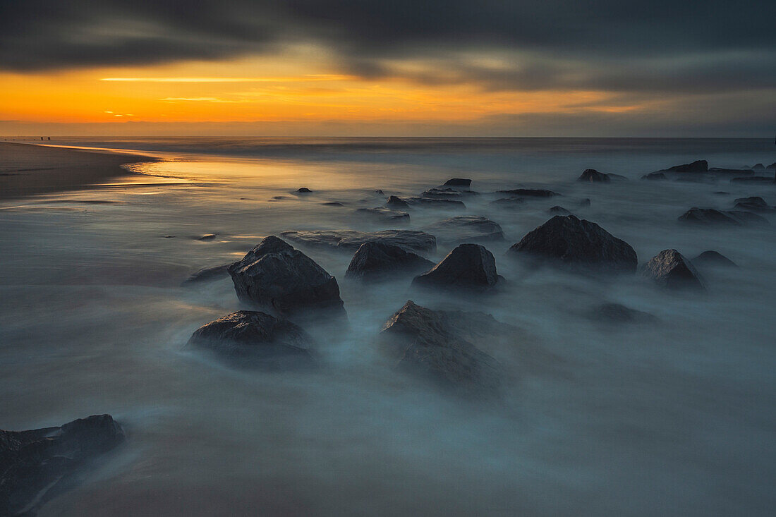 USA, New Jersey, Cape May National Seashore. Sunrise on rocky shoreline.