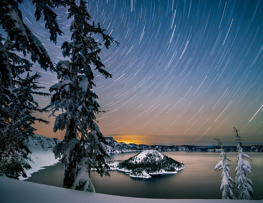 USA, Oregon, Crater Lake National Park. Star trails over Crater Lake and Wizard Island in winter.