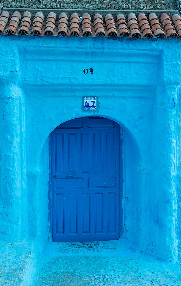 Africa, Morocco, Chefchaouen. Arch over wooden door.