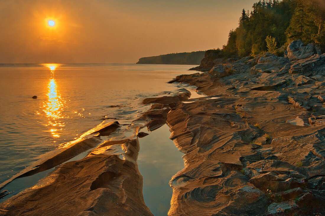 Canada, Ontario, Bruce Peninsula National Park. Sunset on limestone rock.