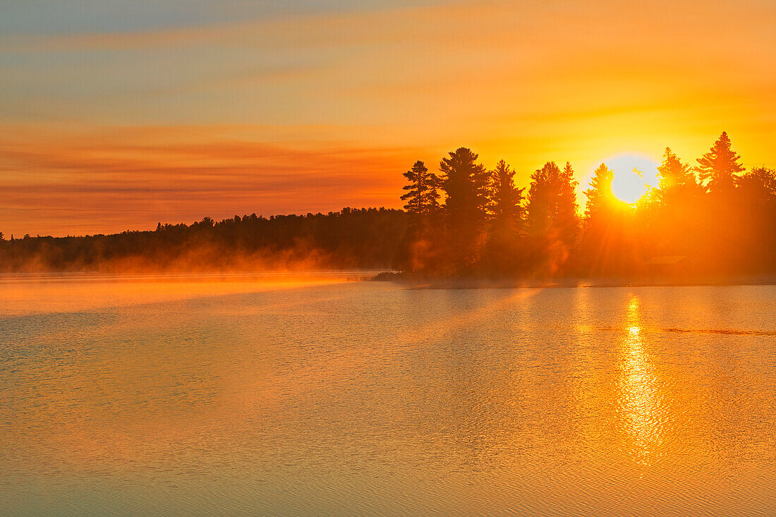 Canada, Ontario, Sunrise on Kakabikitchewan Lake.