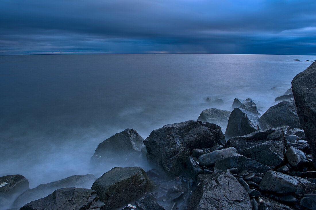 Canada, Quebec, Ruisseau Castor. Waves crashing along the shoreline along the Gulf of St. Lawrence in storm light Ruisseau Castor.