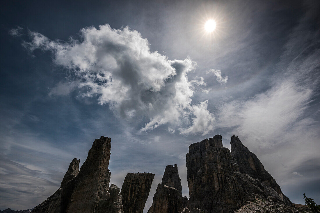 Italy, Dolomites, Cinque Torri. Mountain peaks and sun.