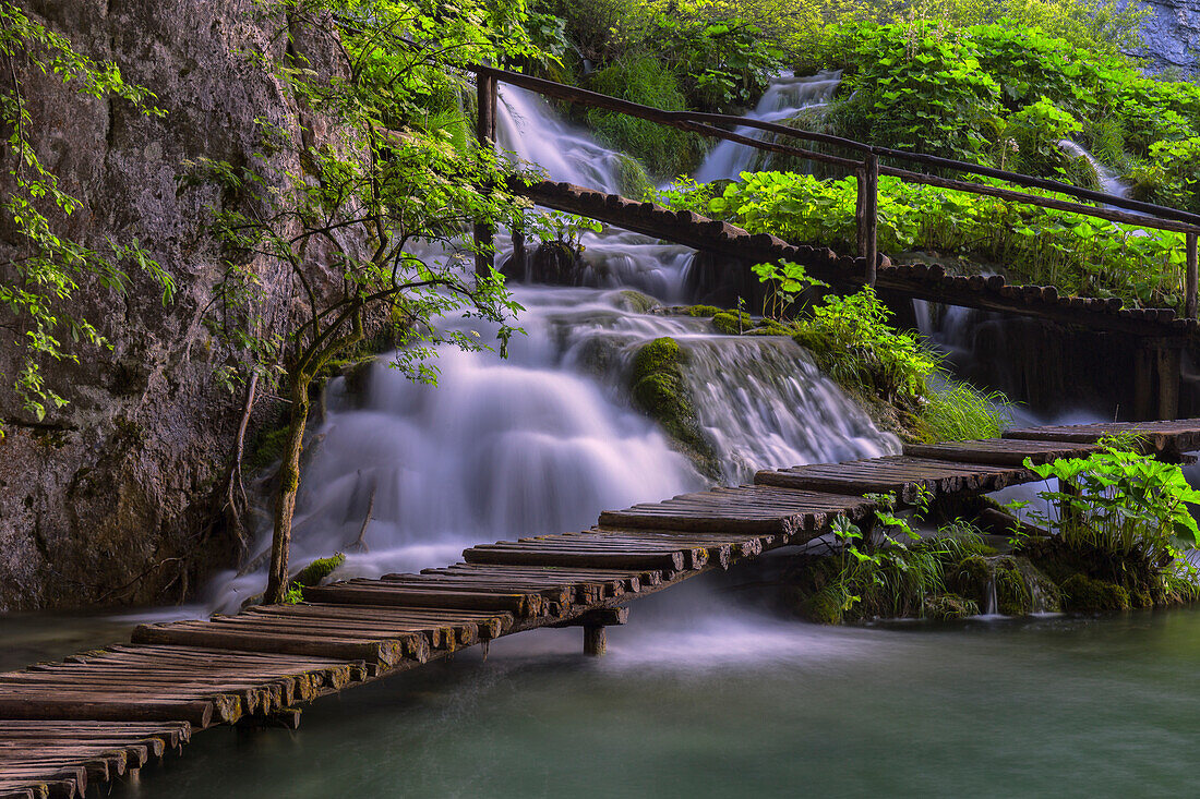 Croatia, Plitvice Lakes National Park. Scenic of waterfall and wooden walkway.