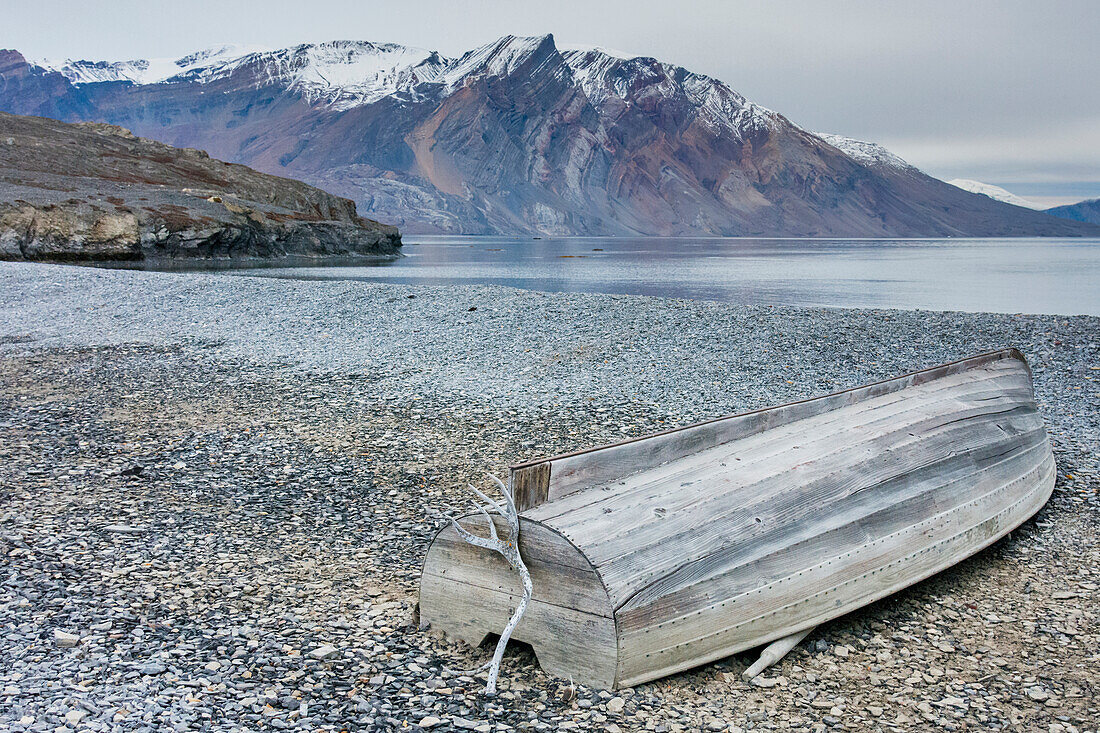 Greenland. Northeast Greenland National Park, Kong Oscar Fjord. Ella Island. Weathered boat on the shore.