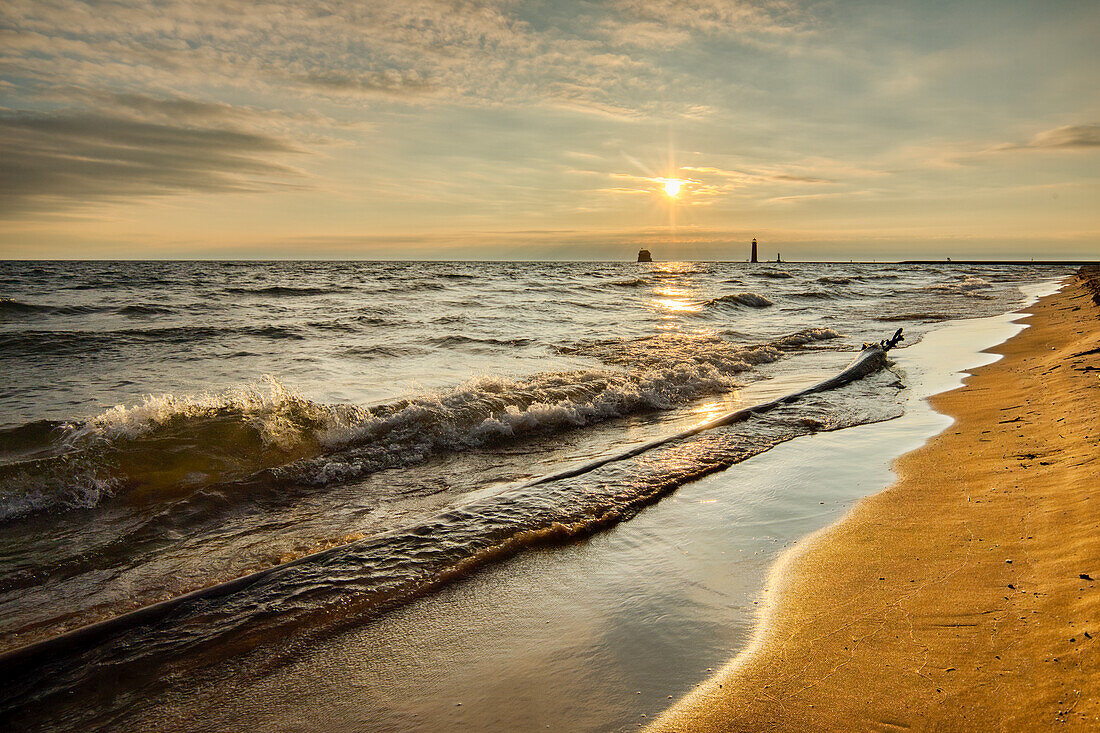 Shoreline of Lake Michigan and distant Grand Haven Lighthouse and pier, Grand Haven, Michigan
