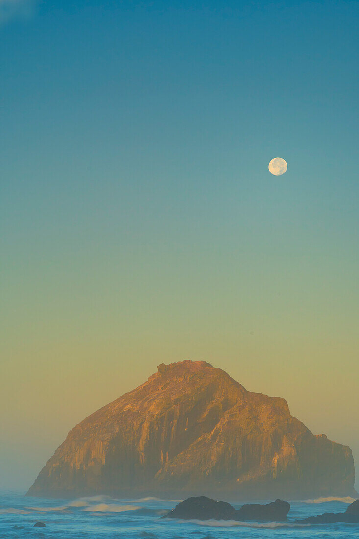 USA, Oregon, Bandon. Moonset and sea stack.