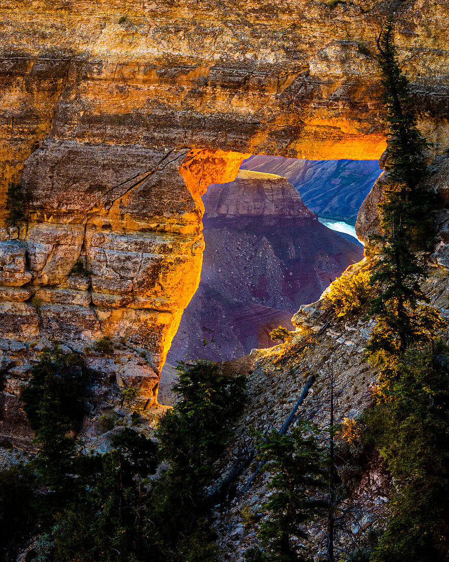 USA, Arizona, Grand Canyon National Park. View through hole in canyon wall at sunrise