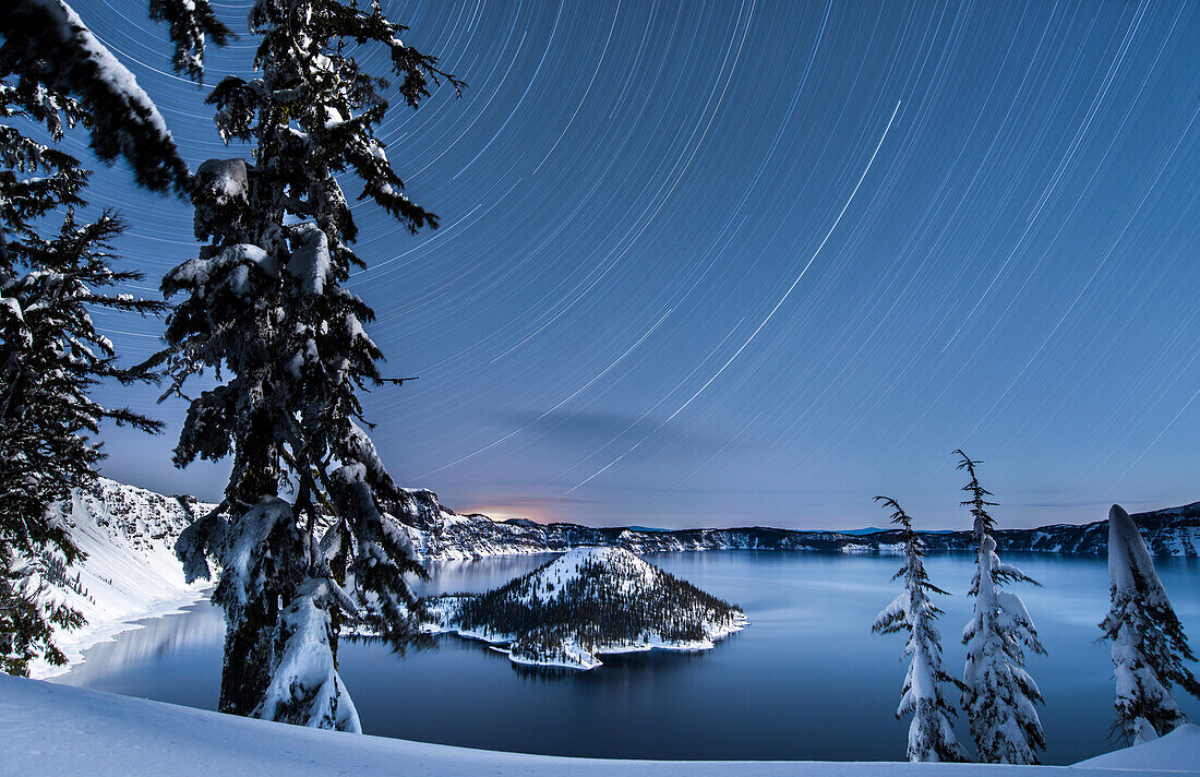 USA, Oregon, Crater Lake National Park. Star trails over Crater Lake and Wizard island in winter.