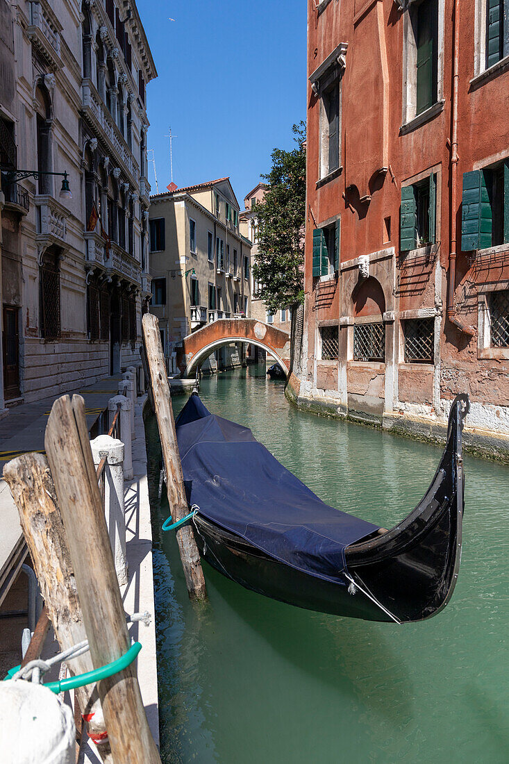 Gondola moored in Rio di San Tommaso, Venice, Veneto, Italy.